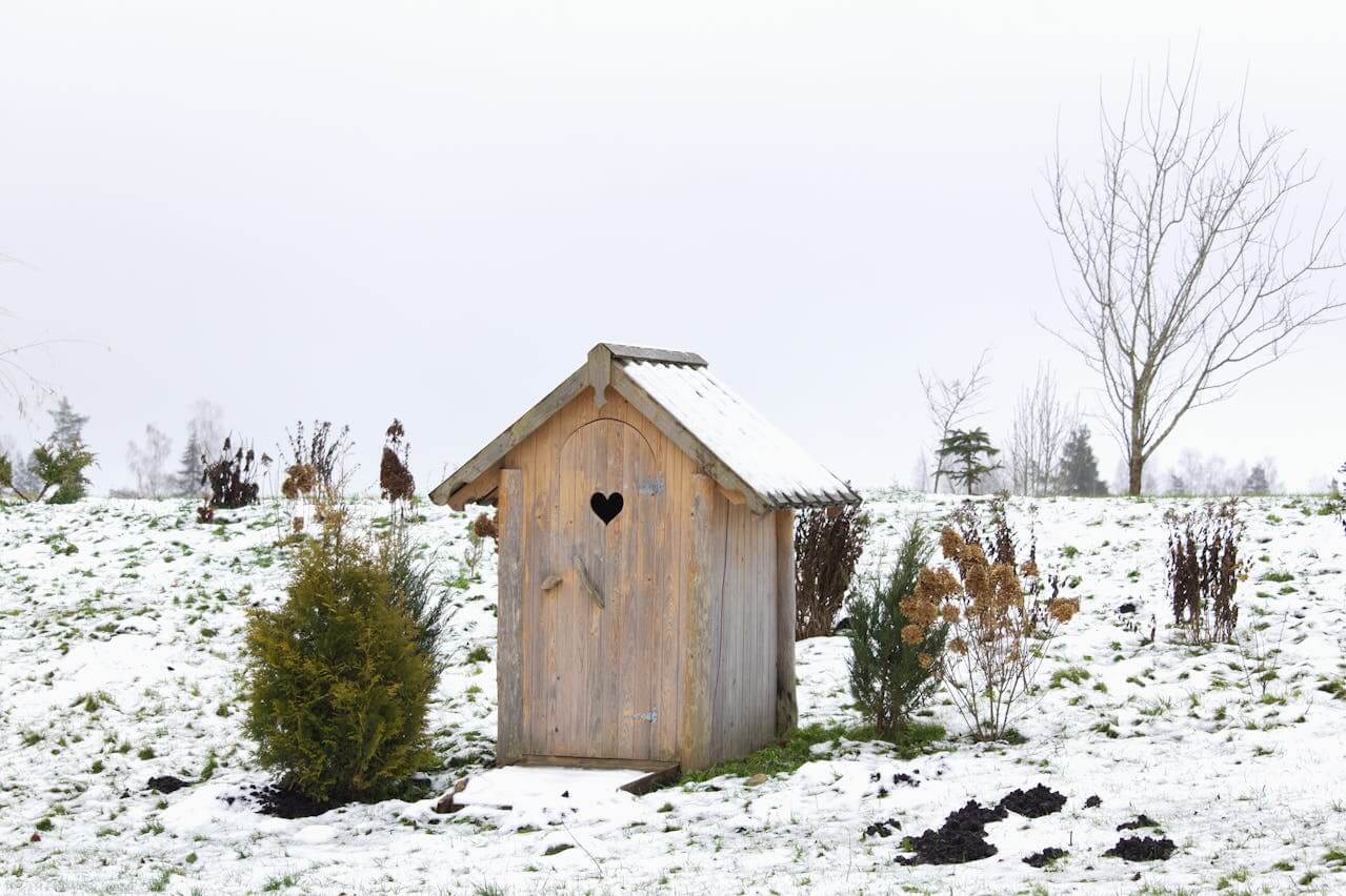 Small wooden house in winter landscape